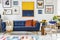 Blanket on navy blue settee in modern living room interior with