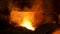 The blast furnace with flowing liquid metal and flying sparkles. Stock footage. Close up of the hot metal production at