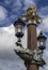 Blauwbrug Blue Bridge in Amsterdam. columns decorated with lanterns. The tops of the columns are crowned with the crowns of the Au