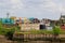 Blaydon UK: May 2022: Scrapyard. Machinery processing piles of scrap metal in a junkyard surrounded by green trees