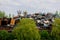 Blaydon UK: May 2022: Scrapyard. Machinery processing piles of scrap metal in a junkyard surrounded by green trees