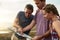 Blazing brave new trails together. three young hikers consulting a map while exploring a new trail.