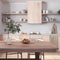 Bleached wooden rustic kitchen and dining room in white and beige tones. Cabinets and table with chair. Parquet floor. Farmhouse