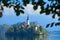 Bled lake island, St Martin Catholic church and Castle with mountain Range, Slovenia, Europe. Autumn day on the lake, sunny say. G