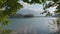 Bled lake, Slovenia. Camera moves through tree branches near Bled lake and island with church
