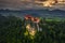 Bled, Slovenia - Aerial drone view of beautiful illuminated Bled Castle Blejski Grad with dark rain clouds, golden sunset