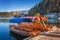 Bled, Slovenia - Traditional red, orange and blue Pletna boats in the autumn sunshine at Lake Bled