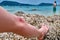 Bleeding on the knee boy. Child wounded his leg against coral reef on tropical beach. Concept of safety when swimming in the sea.