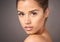 Blemish free skin is beautiful skin. Studio portrait of a beautiful young woman with flawless skin posing against a gray