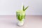 blended brew matcha latte with straw on light gray background