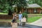 A blended family mom and dad and two young children holding packing boxes and moving into their new home