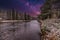 Blended image of nighttime river landscape with starry sky