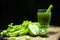 Blended mixed juice Celery and Kiwi and Green apple in welcome drink glass and bunch of fresh celery stalk on wooden table with