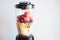 A blender filled with fresh whole fruits for making a smoothie or juice. Healthy eating concept