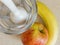 Blender, glass and fruit, banana and apple recipe for smoothie