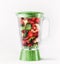 Blender with red fruits: strawberries, raspberries, mint leaves and pomegranate seeds. Refreshing smoothie preparation with