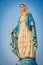 The blessed Virgin Mary statue figure. Catholic praying for our lady - The Virgin Mary. Blue sky copy space on background