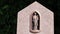 Blessed virgin mary statue with Jesus Christ as baby on a cemetery graveyard or gravestone shows holy madonna as sacral memorial a