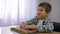 Blind child boy reading braille book with symbols font for Visually impaired sitting at table