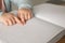 Blind child reading book written in Braille