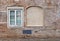 Blind curved basement windows in the old aged red bricks house.