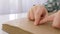 Blind kid hands reading braille book with symbols font for Visually impaired close up sitting at table