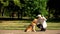 Blind male stroking guide dog in park, best friend of people, guidance concept