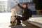 Blind man training golden retriever outdoors, giving obedience command