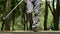 Blind man with white cane walking along park, life of visual impairment people