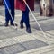 Blind man and woman walking on the street