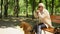 Blind pensioner with assistance purebred dog sitting lonely in park, depression