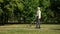 Blind pensioner safely navigate using white cane, walking independent in park