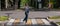 Blind pregnant woman crosses the road at a crosswalk with a cane.