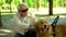 Blind senior man lovingly stroking guide dog, feeling gratitude for help, friend