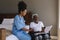 Blind senior man reading a braille with female doctor