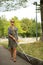 Blind woman walking on city streets, using her white cane