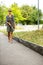 Blind woman walking on city streets, using her white cane