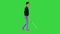 Blind young man with a cane walking on a Green Screen, Chroma Key.