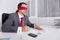 Blindfold businessman working with his laptop