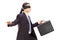 Blindfolded young businessman with briefcase