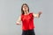 Blindness! Portrait of worry beautiful brunette young woman in red shirt standing with closed eyes and try to touch or find