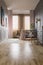 Blinds in spacious child`s bedroom with pink drapes and grey cab