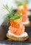 Blini with smoked salmon and sour cream, garnished with dil