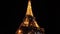 Blinking flickering of Eiffel tower in Paris at night. Warm glowing huge metal construction