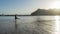 Bliss Teenager splashing while kick the water with the leg, having fun in the sea walking in the sunset. Lady laugh and splash