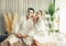 Blissful couple in bathrobe with facial cream mask. Quiescent