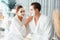 Blissful couple in bathrobe with facial cream mask. Quiescent