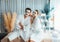 Blissful couple in bathrobe with facial cream mask. Quiescent