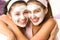 Blissful girls applying mask hugging each other