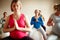 Blissful maternity. A multi-ethnic group of pregnant women meditating on exercise balls in a yoga class.
